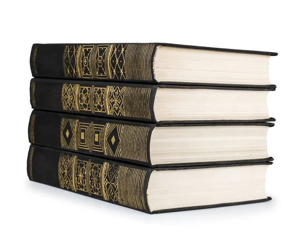 Stack of vintage books black with gold pattern on a white backgr — Stock Photo, Image