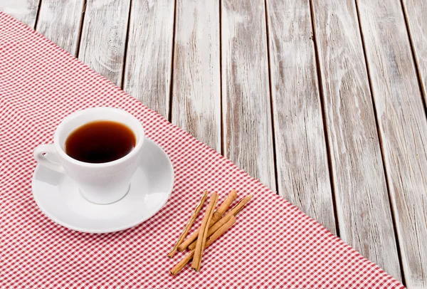 La taza del café sobre la tela sobre la mesa de madera — Foto de Stock