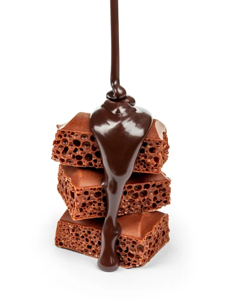 Slices of milk  chocolate bar poured dark chocolate isolated on — Stock Photo, Image