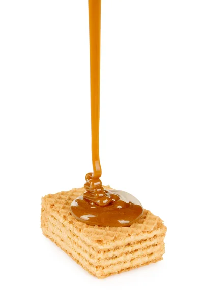 Sweet caramel sauce is poured on a waffle cookies — Stock Photo, Image