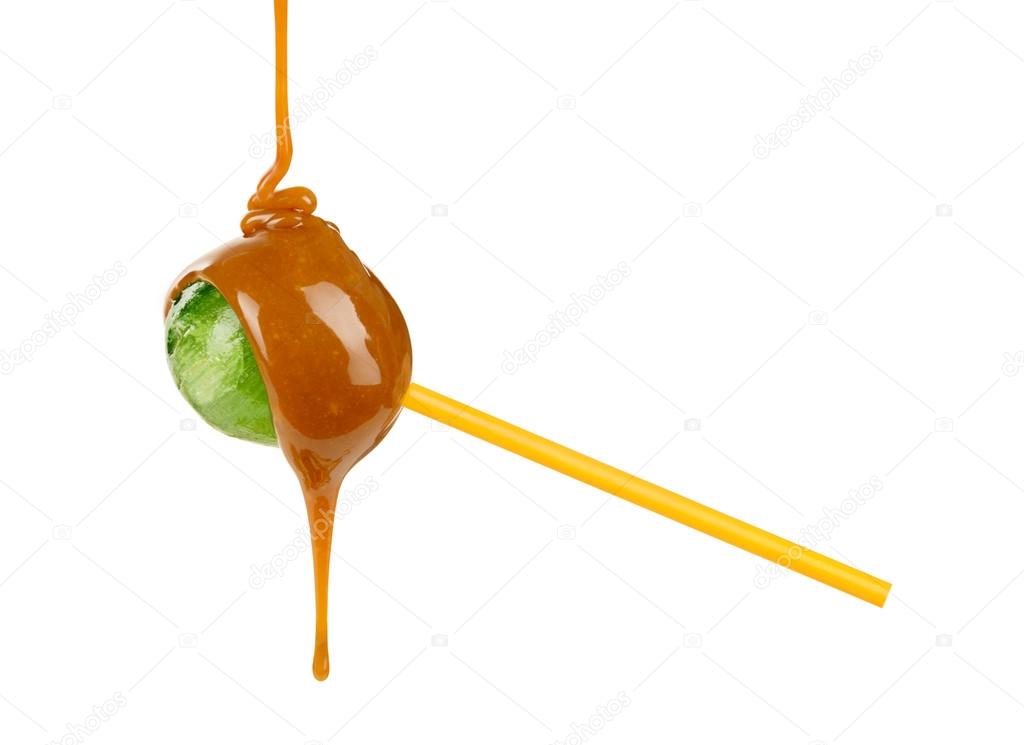 Caramel is poured on a lollipop on a white background