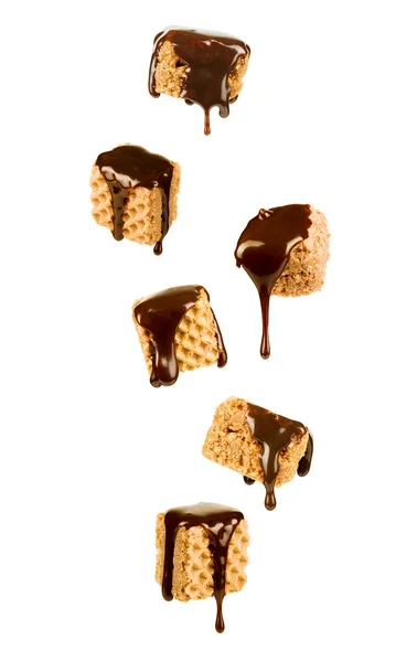 Chocolate syrup pouring over a sweet wafer cookies — Stock Photo, Image