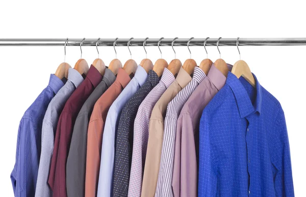 Variedad de camisas en perchas de madera —  Fotos de Stock