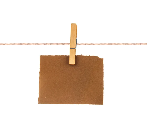 Old blank sheet of paper hanging on a rope with clothespin — Stock Photo, Image