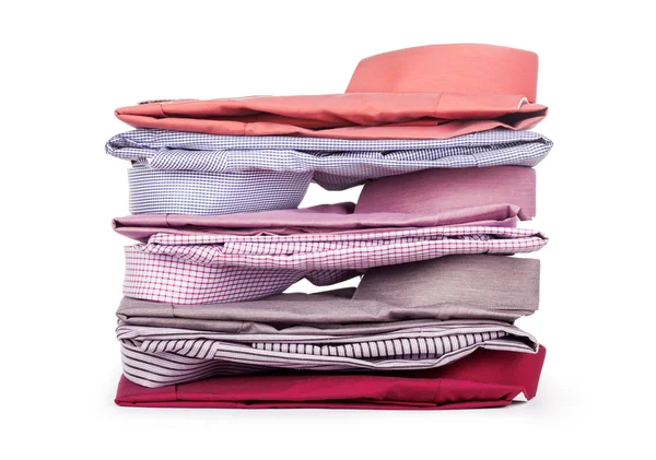 Pilhas de muitas roupas coloridas isoladas em um fundo branco — Fotografia de Stock