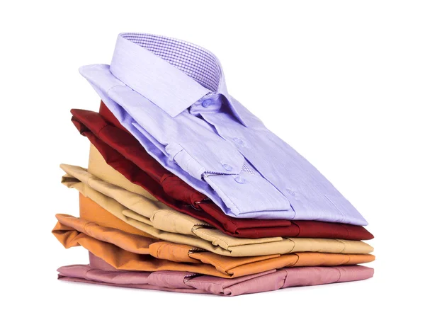 Stacks of many colored clothes isolated on a white background — Stock Photo, Image