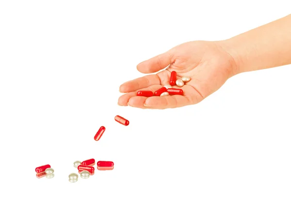 Pills falling out of hand on white background — Stock Photo, Image