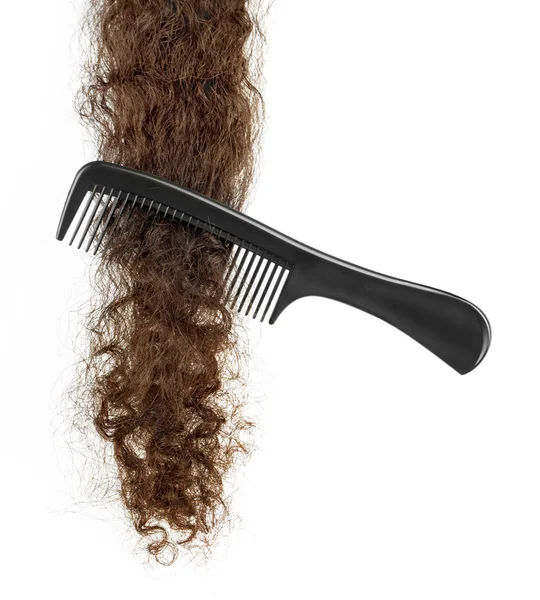Spazzola per capelli e ciocca di capelli su un bianco — Foto Stock