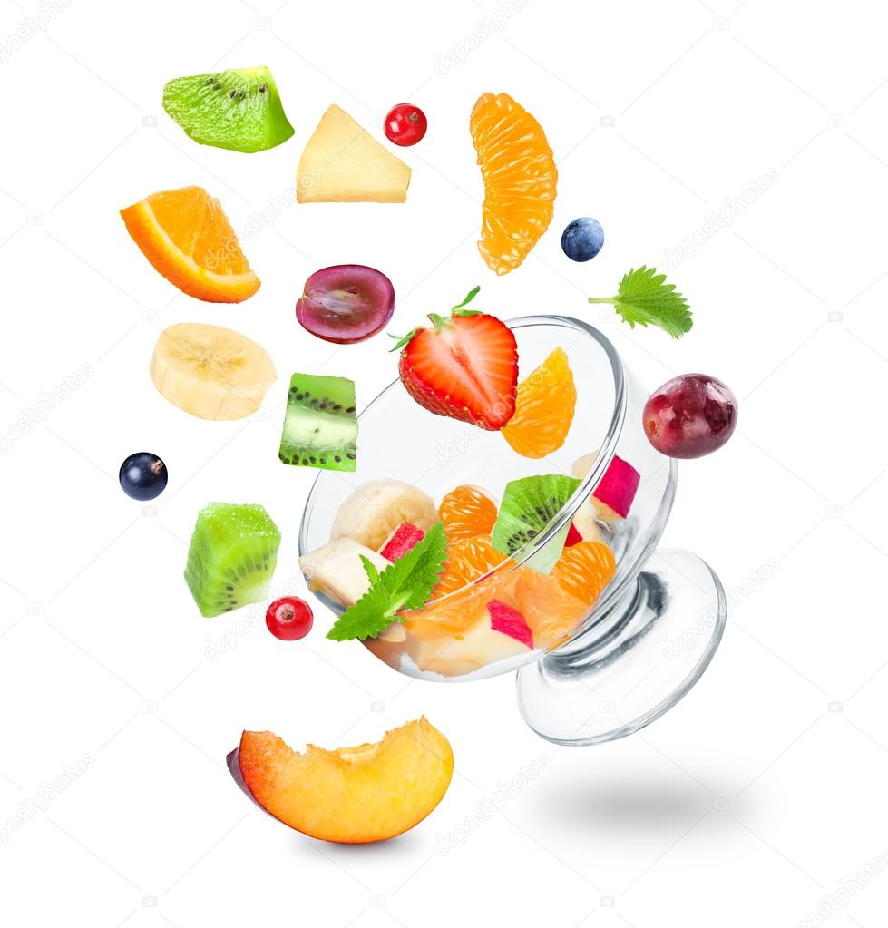 Delicious fresh fruit salad falling on a white background