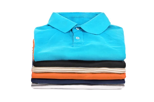 Stack of T-shirts on a white background — Stock Photo, Image