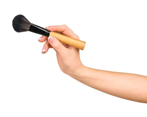Ręka trzyma pędzel profesjonalny makijaż na biały backg — Zdjęcie stockowe