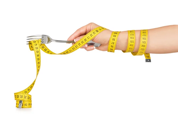 Hand holding a fork with a measuring tape on a white background — Stock Photo, Image