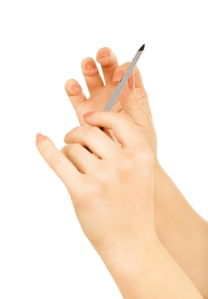 Mãos com arquivo de unhas isolado no branco — Fotografia de Stock