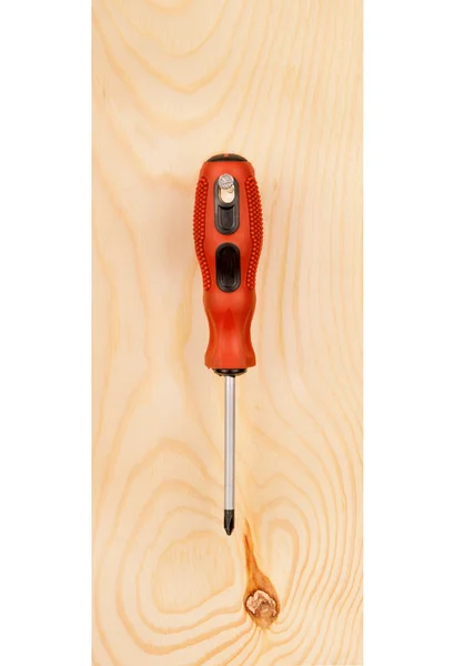 Screwdriver on a wooden board — Stock Photo, Image