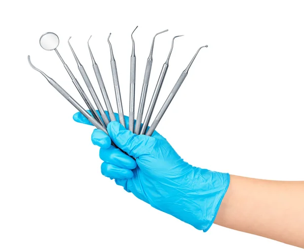 Hand in blue glove holding dental tools isolated on white backgr — Stock Photo, Image