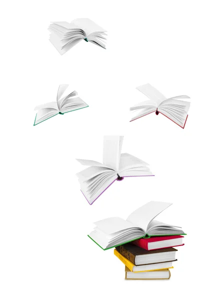 Stack di libri e libri volanti isolati su bianco — Foto Stock