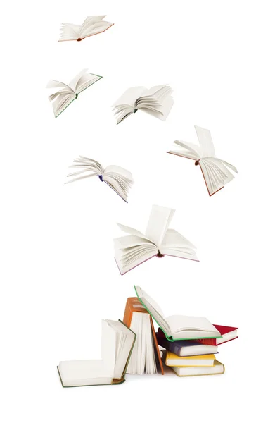 Bücherstapel und fliegende Bücher isoliert auf weiß — Stockfoto