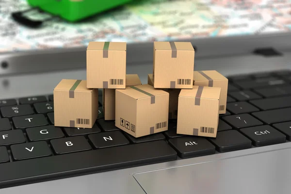 Shipping, delivery and logistics technology business industrial concept: macro view of heap of stacked corrugated cardboard package boxes on computer PC laptop notebook keyboard with selective focus — Stock Photo, Image