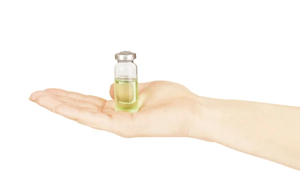 Medical ampoule in a hand on a white background — Stock Photo, Image