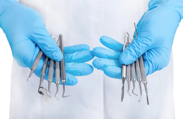 Instrumenty stomatologiczne trzymając się za ręce — Zdjęcie stockowe