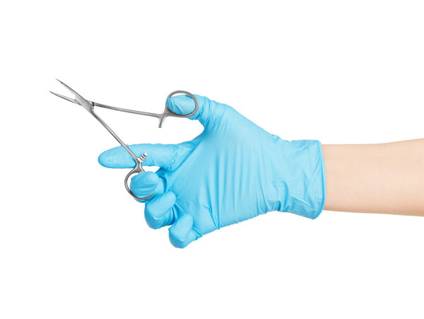 Medical scissors in the hands of a doctor