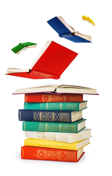 Stack of old books and flying books isolated on white — Stock Photo, Image