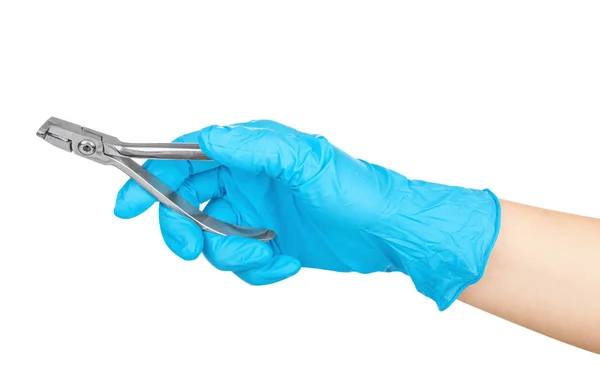 Gloved hand holding a pliers to remove teeth isolated on white b — Stock Photo, Image