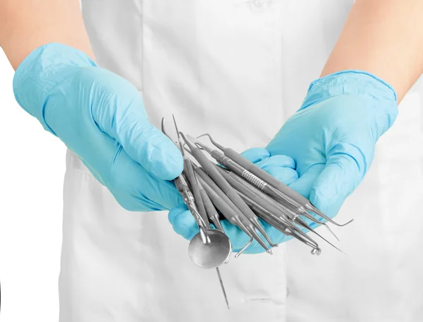 A dentists hands in blue medical gloves with dental tools — Stock Photo, Image