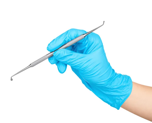 Gloved hand holding a metal dental tool trowel round head on an — Stock Photo, Image