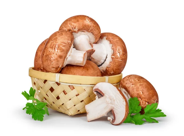Fresh mushrooms in a basket with parsley on an isolated white ba — Stock Photo, Image