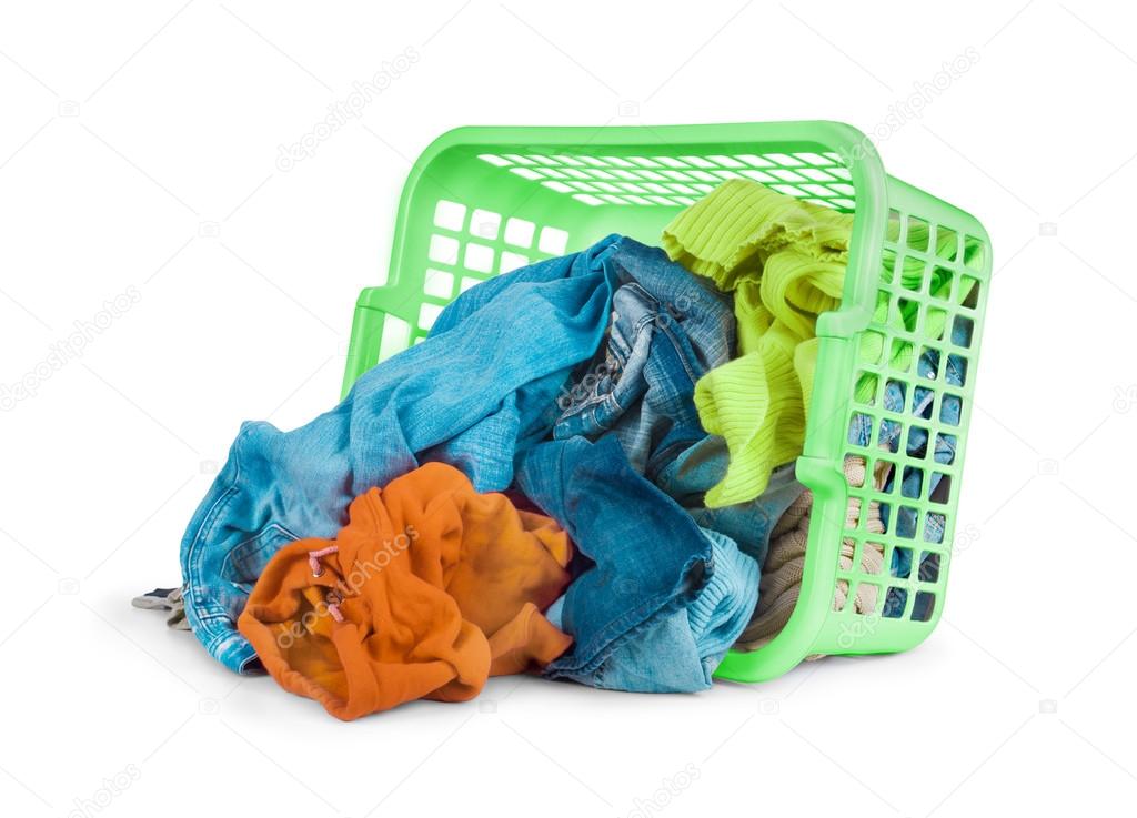 Bright clothes in a laundry basket on white background