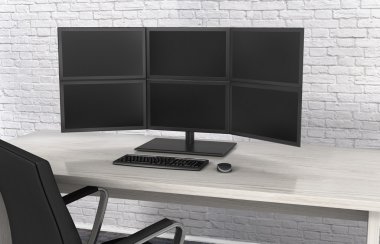 Monitörler masanın üzerinde arka plan bir tuğla duvar