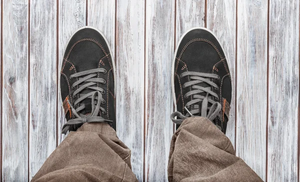 Gray sneakers on white wooden background. — Stock Photo, Image