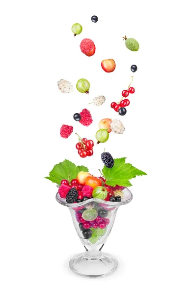 Salad with fresh falling fruits and berries in glass on white ba — Stock Photo, Image