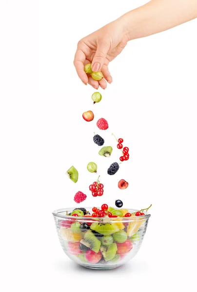 Mixed falling berries and fruits in bowl on white background — ストック写真