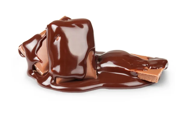 Chocolate syrup being poured over stack of bars on white backgro — Stok fotoğraf