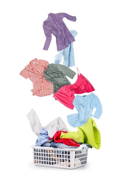 Laundry in a basket and falling clothes - isolated on a white ba — Stock Photo, Image