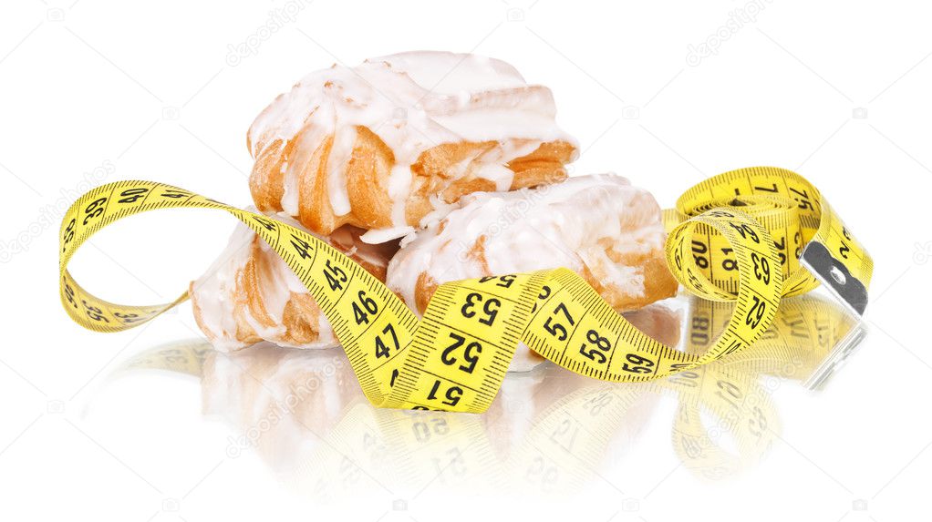 concept of slimming, cakes with measuring tape on white 