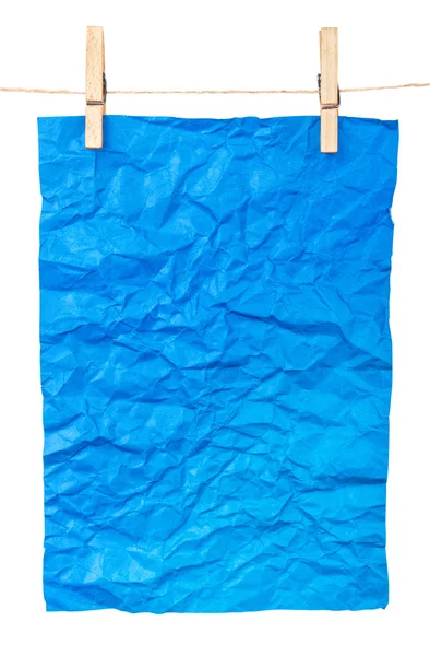 Blauw papier-een poster over wasknijpers — Stockfoto