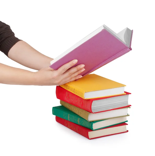 Ruka držící knihu izolovaných na bílém — Stock fotografie