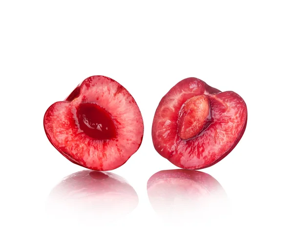 Les deux moitiés de cerises juteuses sur fond isolé — Photo