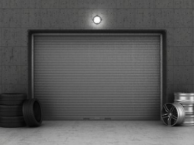 Garage building made of concrete with roller shutter doors, tire