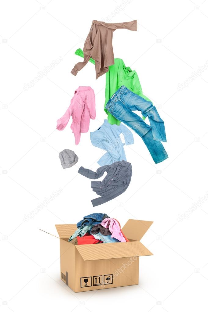 clothes falling into the cardboard box isolated on white 