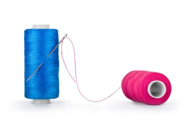 Needle and spools of thread isolated on white
