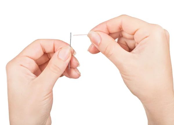 Hands passing a thread in a needle — Stock Photo, Image