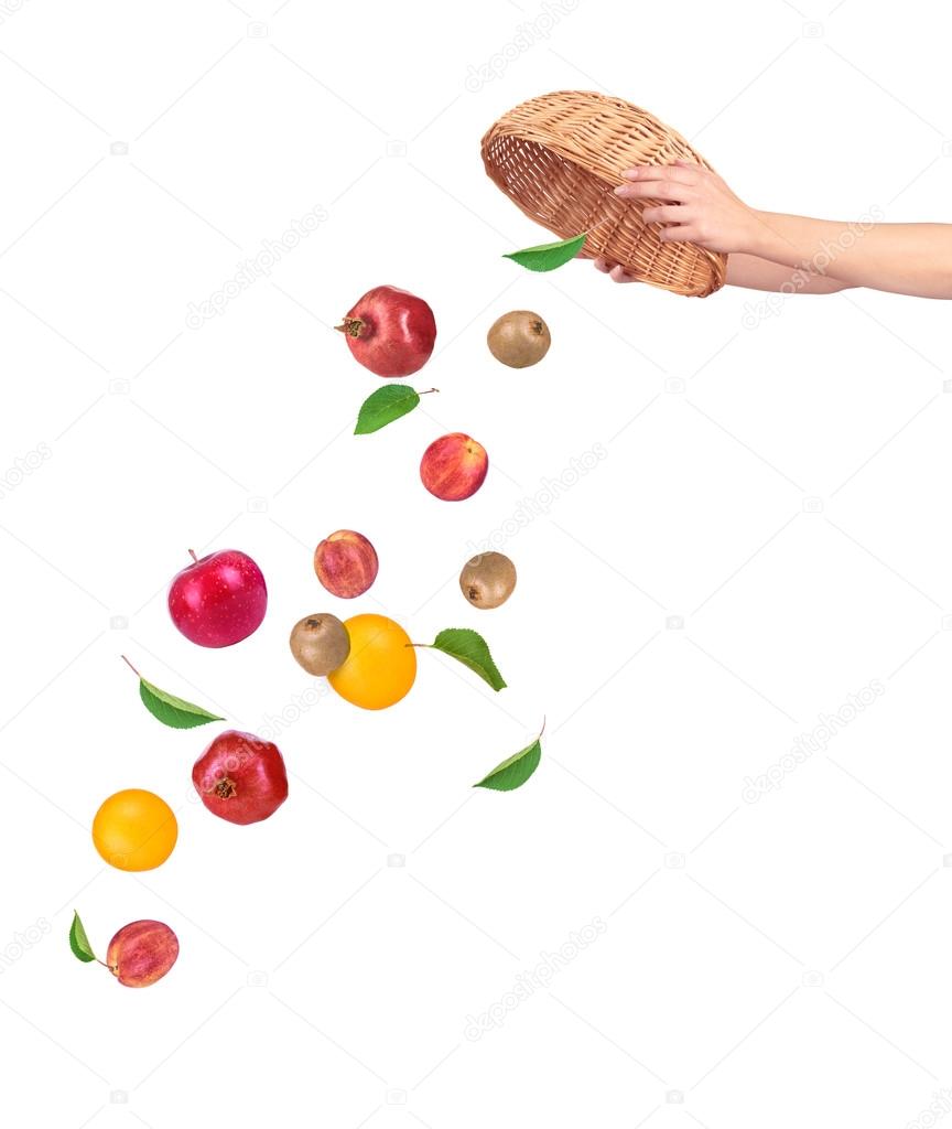 Fruit falling from basket isolated on a white background Stock Photo by
