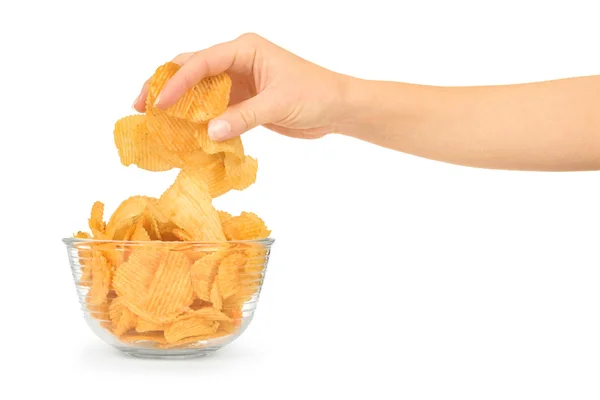 Hand with potato chips and bowl on white background — Stock Photo, Image