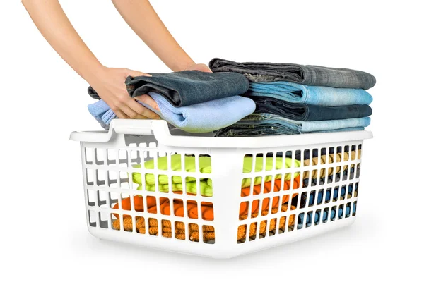 Laundry basket with folded clothes over white background — Stock Photo, Image