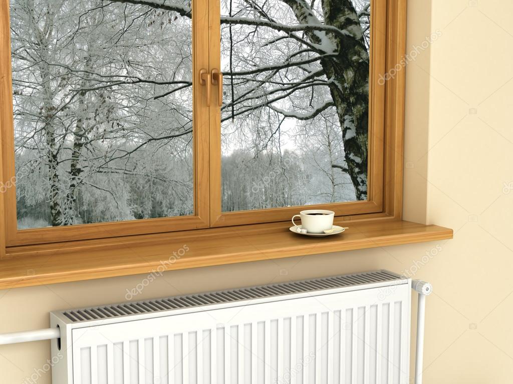 White radiator near the window, warm and cozy