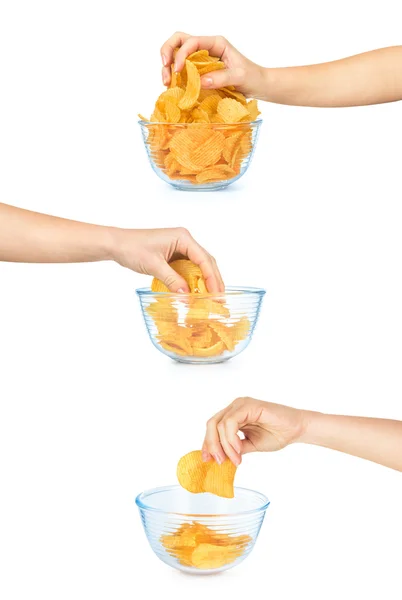 Hand takes a handful of potato chips from a glass bowl isolated — Stock Photo, Image